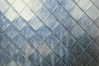 Close-up of a textured metal surface with geometric patterns, captured in Busan, South Korea.